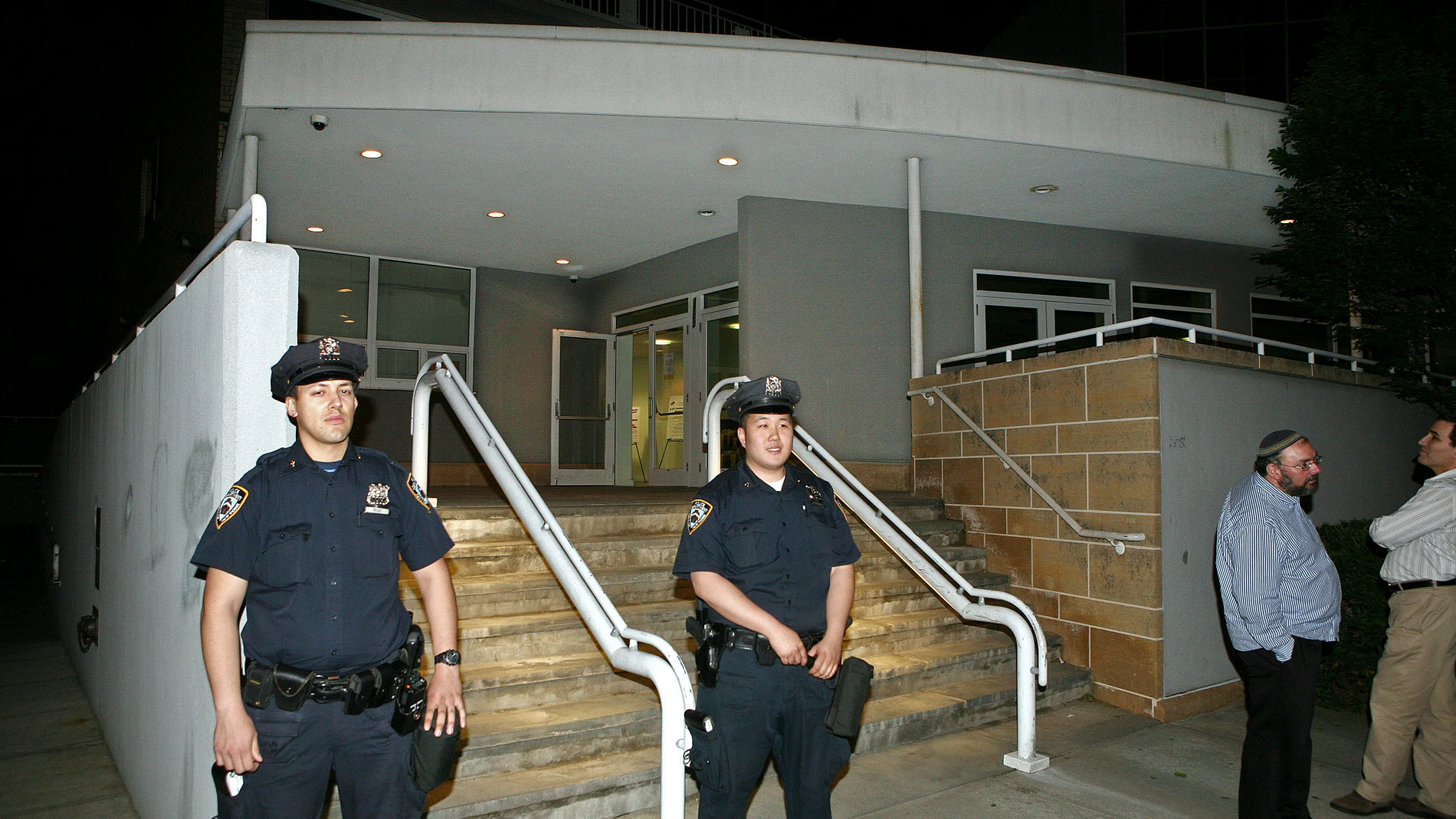 FILE - New York Police officers stand outside the Riverdale Jewish Center in the Bronx section in New York where alleged terrorists attempted to plant bombs in a plot which was foiled by police and FBI Wednesday, May, 20, 2009 The four men snared in an infamous post-9/11 terrorism sting were ordered freed from prison last week, a judge finding that they had been "hapless, easily manipulated and penurious petty criminals" caught up in a plot driven by an overzealous FBI and a dodgy informant. ...