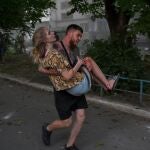 A man carries an injured Ukrainian woman after an explosion of a second rocket in the city of Pokrovsk, Donetsk area, Ukraine, 07 August 2023, amid the Russian invasion.