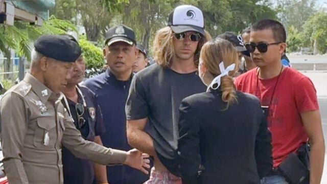 A handout photo made available by Royal Thai Police shows a Spanish chef, a murder suspect Daniel Jeronimo Sancho Bronchalo, (C) is escorted by Thai police officers during a crime reenactment at a scene in Koh Phangan island, southern Thailand,