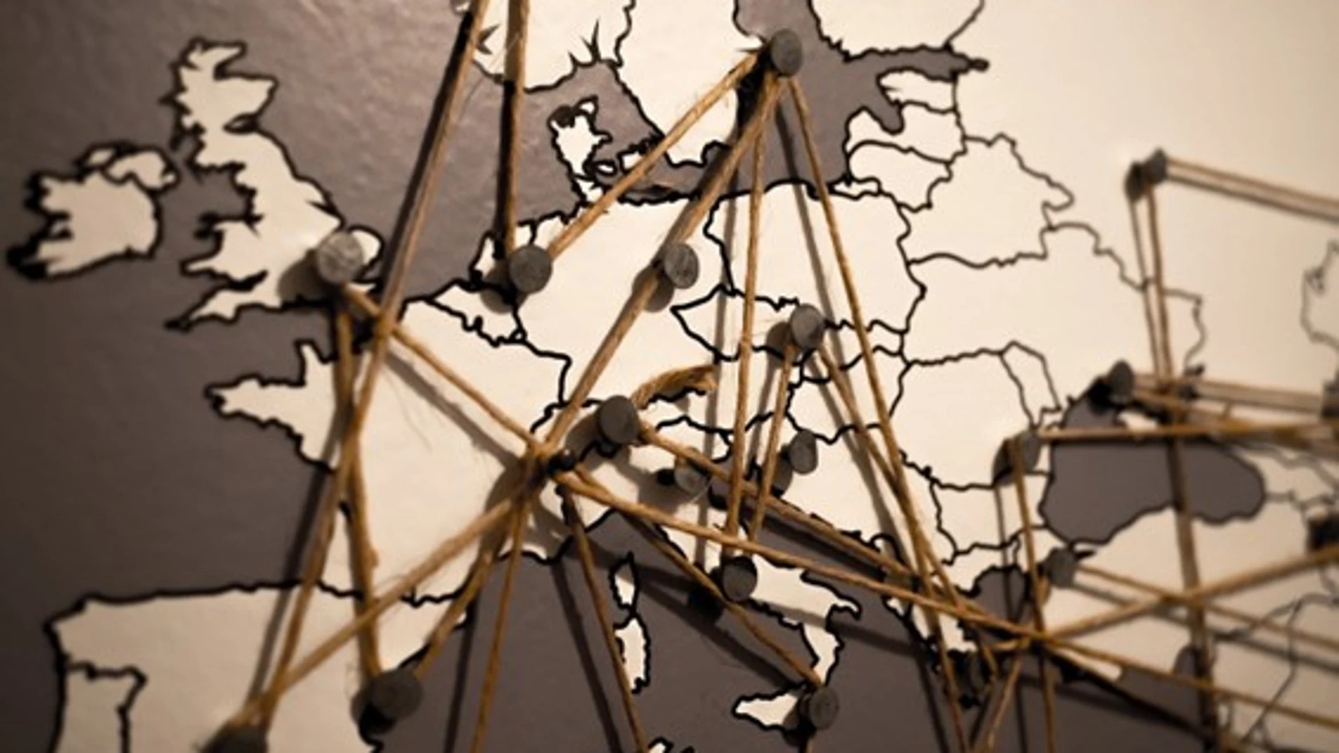 Mapa de Europa con chinchetas conectadas por cordeles 