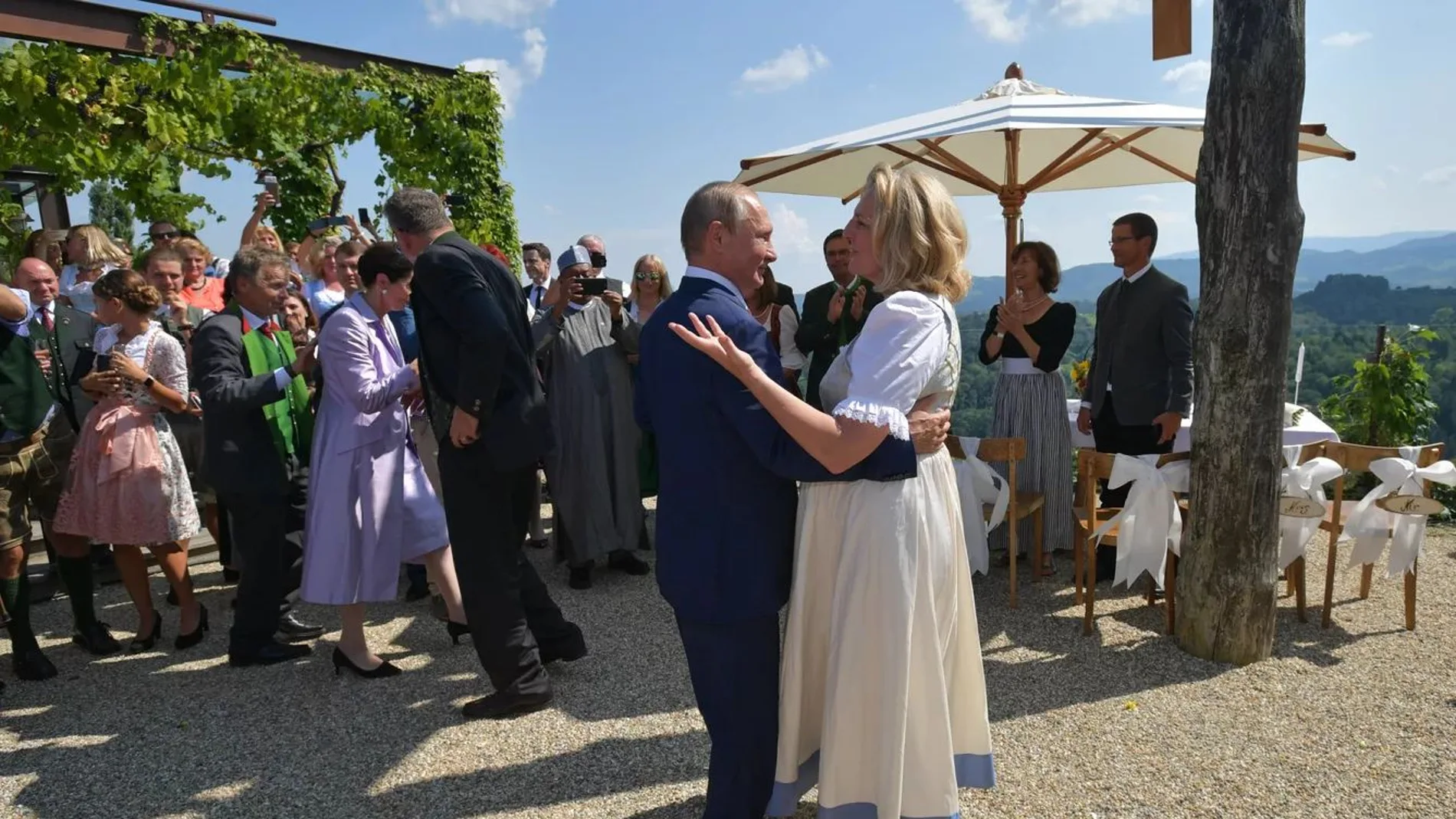 Austria's Foreign Minister Karin Kneissl dances with Russia's President Vladimir Putin at her wedding in Gamlitz, Austria, August 18, 2018.