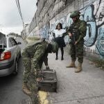 Soldiers inspect a car at a security check point placed in Quito, Ecuador, Tuesday, Aug. 15, 2023. The unprecedented violence shaking Ecuador claimed the life of another political leader Monday, bringing the number of politics-related slayings within the last four weeks to three, including that of a presidential candidate. (AP Photo/Dolores Ochoa)