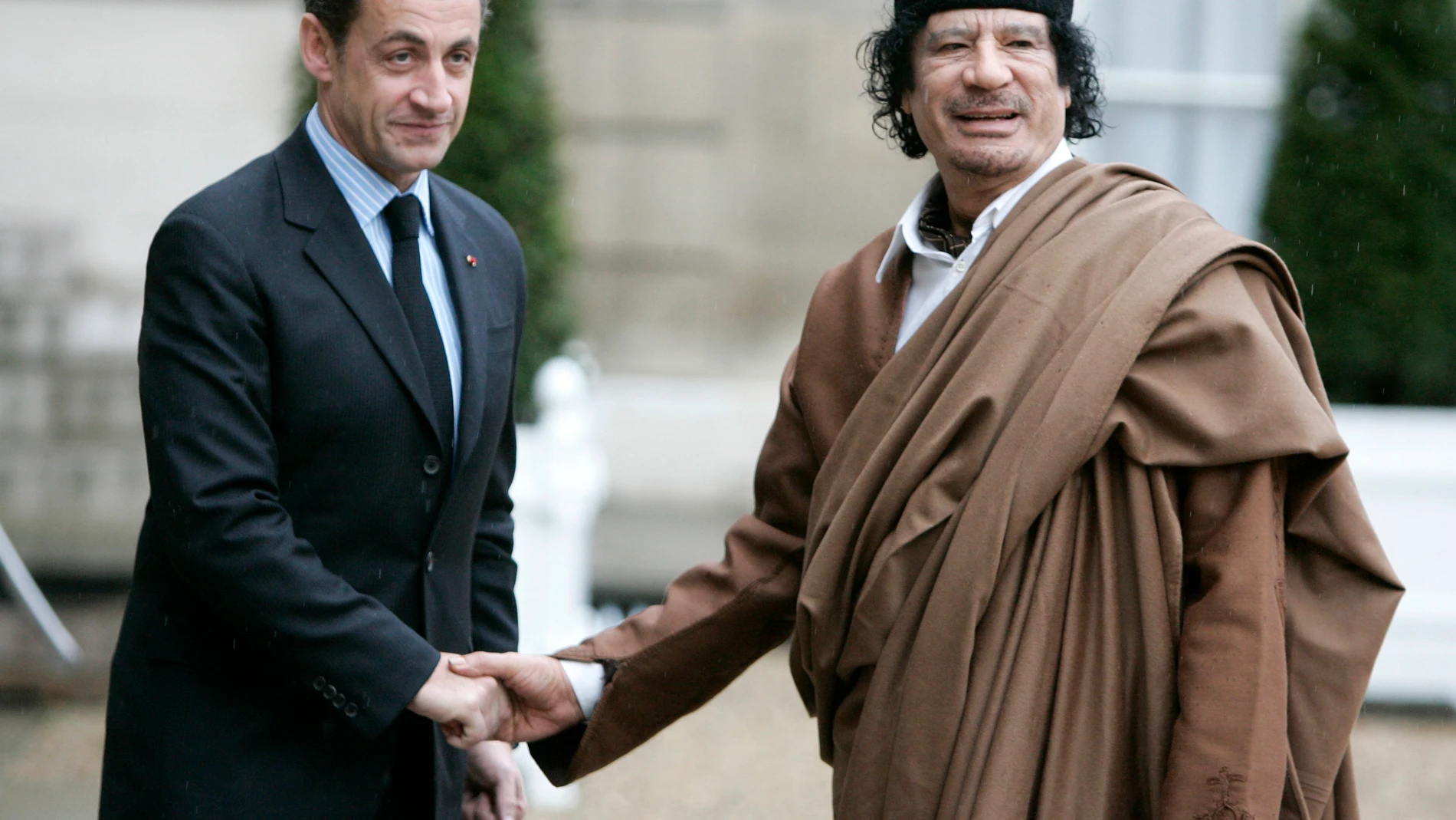 FILE - French President Nicolas Sarkozy, left, greets Libyan leader Col. Moammar Gadhafi upon his arrival at the Elysee Palace, in Paris Dec. 10, 2007. French investigative magistrates on Friday, Aug. 25, 2023, ordered former president Nicolas Sarkozy and 12 others to go on trial on charges that his 2007 presidential campaign received millions in illegal financing from the government of late Libyan leader Moammar Gadhafi. (AP Photo/Francois Mori, File)
