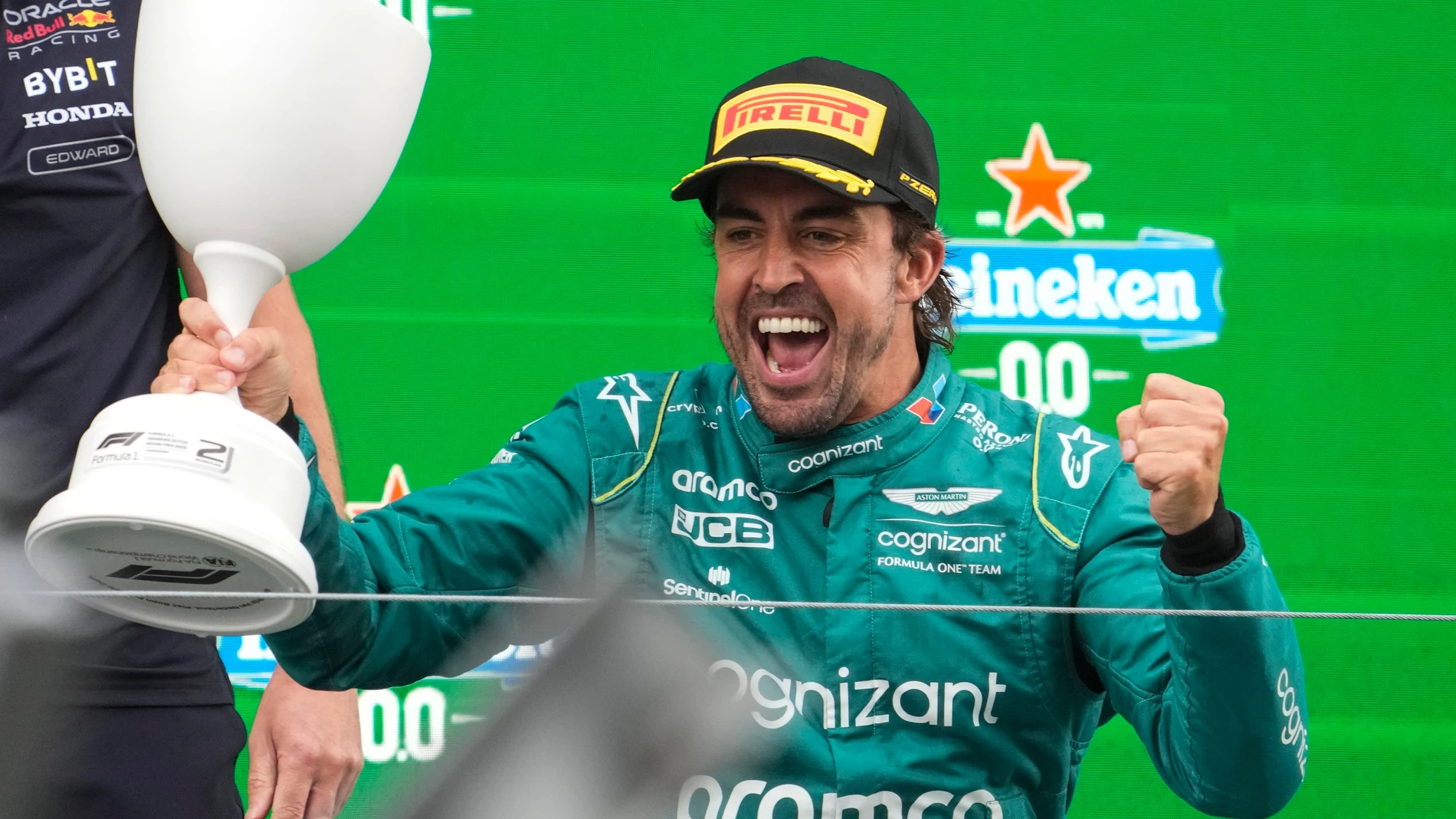 Fernando Alonso of Spain celebrates an the podium after he placed second in the Formula One Dutch Grand Prix, at the Zandvoort racetrack, in Zandvoort, Netherlands, Sunday, Aug. 27, 2023.(AP Photo/Peter Dejong)