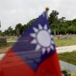  Taiwanese soldiers stand next to the tombstones of the fallen soldiers during the 65th Anniversary of the artillery battle between Taiwan and China, in Kinmen, Taiwan.
