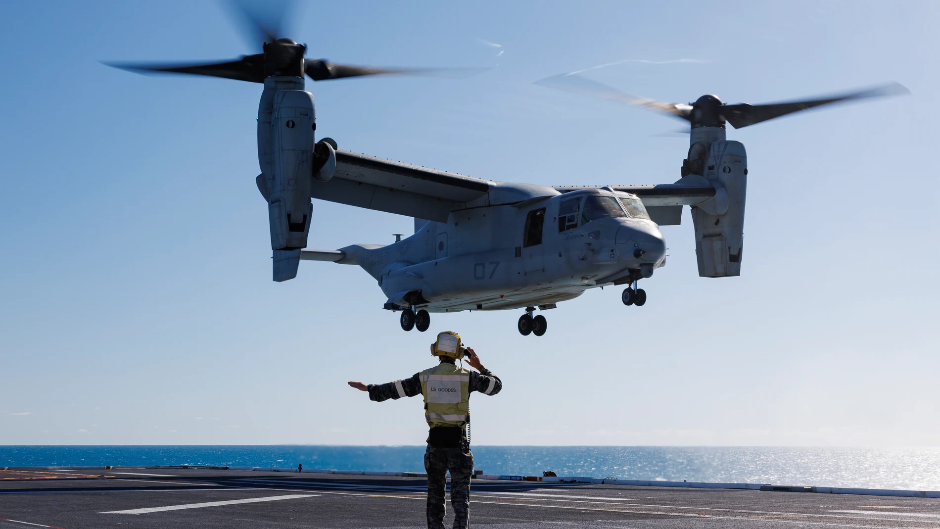 Royal Australian Navy sailor Leading Seaman Jayden Goodes guides a U.S. Marine Corps MV-22 Osprey during take-off and landing practice on the flight deck of HMAS Adelaide in the Whitsunday Islands off the coast of Australia during Exercise Sea Raider, Aug. 7, 2023. The Australian Defense Department said a Bell Boeing V-22 Osprey tiltrotor aircraft crashed on Melville Island, Sunday, Aug. 27, 2023 during Exercise Predators Run, which involves the militaries of the United States, Australia, Ind...