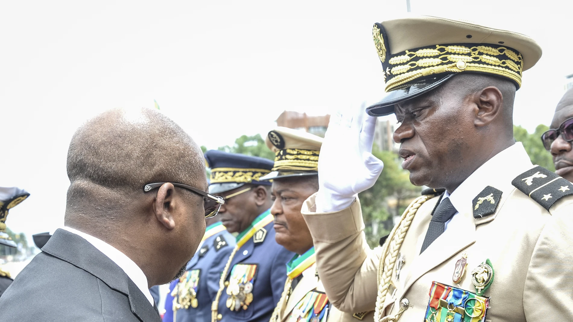  Head of Gabon's elite Republican Guard, General Brice Oligui Nguema (R), is decorated by Gabon Prime Minister Alain Claude Bilie Bie Nze (L) in Libreville on August 16, 2023 during celebrations ahead of Gabon Independence day celebrated on August 17, 2023.