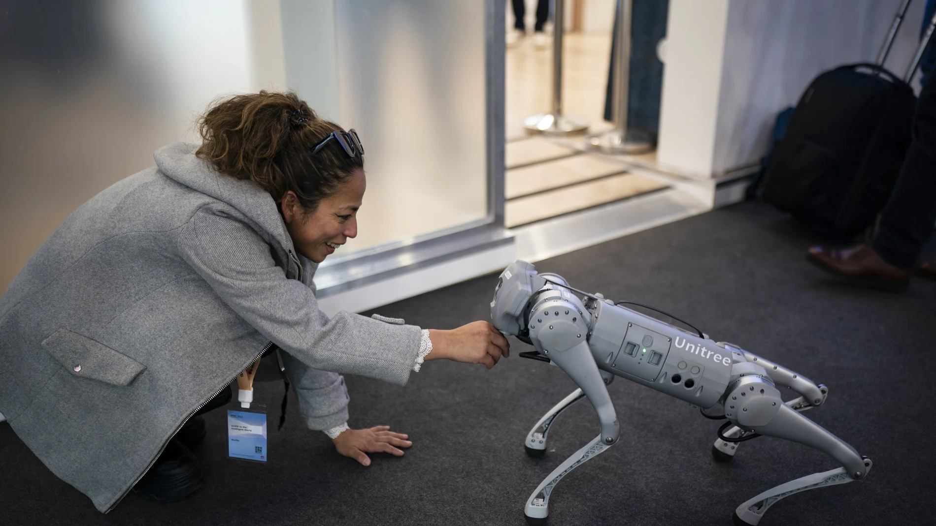 A visitor touches Unitree GO1 ''dog'' robot during the Mobile World Congress 2023 in Barcelona, Spain.