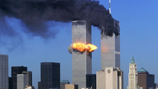 Hijacked United Airlines Flight 175, which departed from Boston en route for Los Angeles, crashes into the South Tower of the World Trade Towers Sept, 11, 2001. The North Tower is shown burning after American Airlines Flight 11 crashed into the tower at 8:45 a.m. 