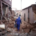 Ouirgane (Morocco), 10/09/2023.- A woman passes by damaged buildings following a powerful earthquake in Ouirgane, south of Marrakesh, Morocco, 10 September 2023. A magnitude 6.8 earthquake that struck central Morocco late 08 September has killed at least 2,012 people and injured 2,059 others, 1,404 of whom are in serious condition, damaging buildings from villages and towns in the Atlas Mountains to Marrakesh, according to a report released by the country's Interior Ministry. The earthquake has affected more than 300,000 people in Marrakesh and its outskirts, the UN Office for the Coordination of Humanitarian Affairs (OCHA) said. (Terremoto/sismo, Marruecos) EFE/EPA/YOAN VALAT
