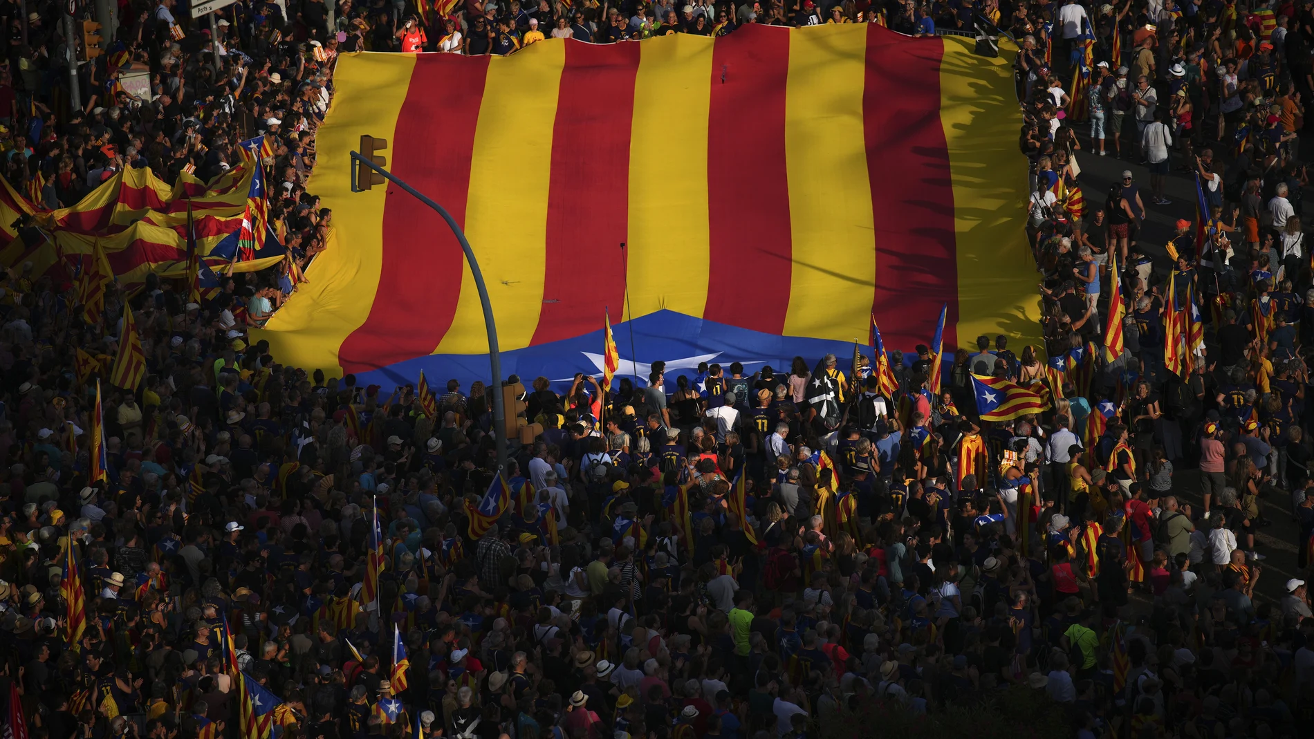 Protesters hold independence flags during a demonstration to celebrate the Catalan National Day in Barcelona, Spain, Monday, Sept. 11, 2023. The traditional September 11, called "Diada", marks the fall of the Catalan capital to Spanish forces in 1714.