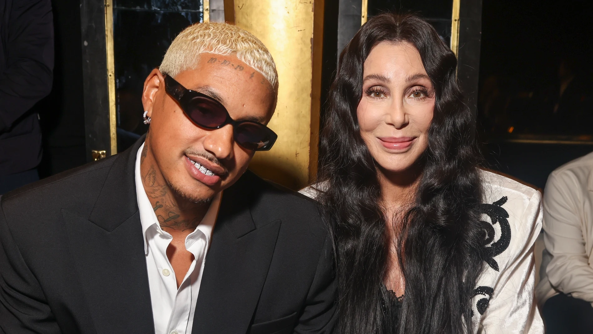 Cher, right, and Alexander Edwards attend the Balmain Spring/Summer 2024 womenswear fashion collection presented Wednesday, Sept. 27, 2023 in Paris. (AP Photo/Vianney Le Caer)