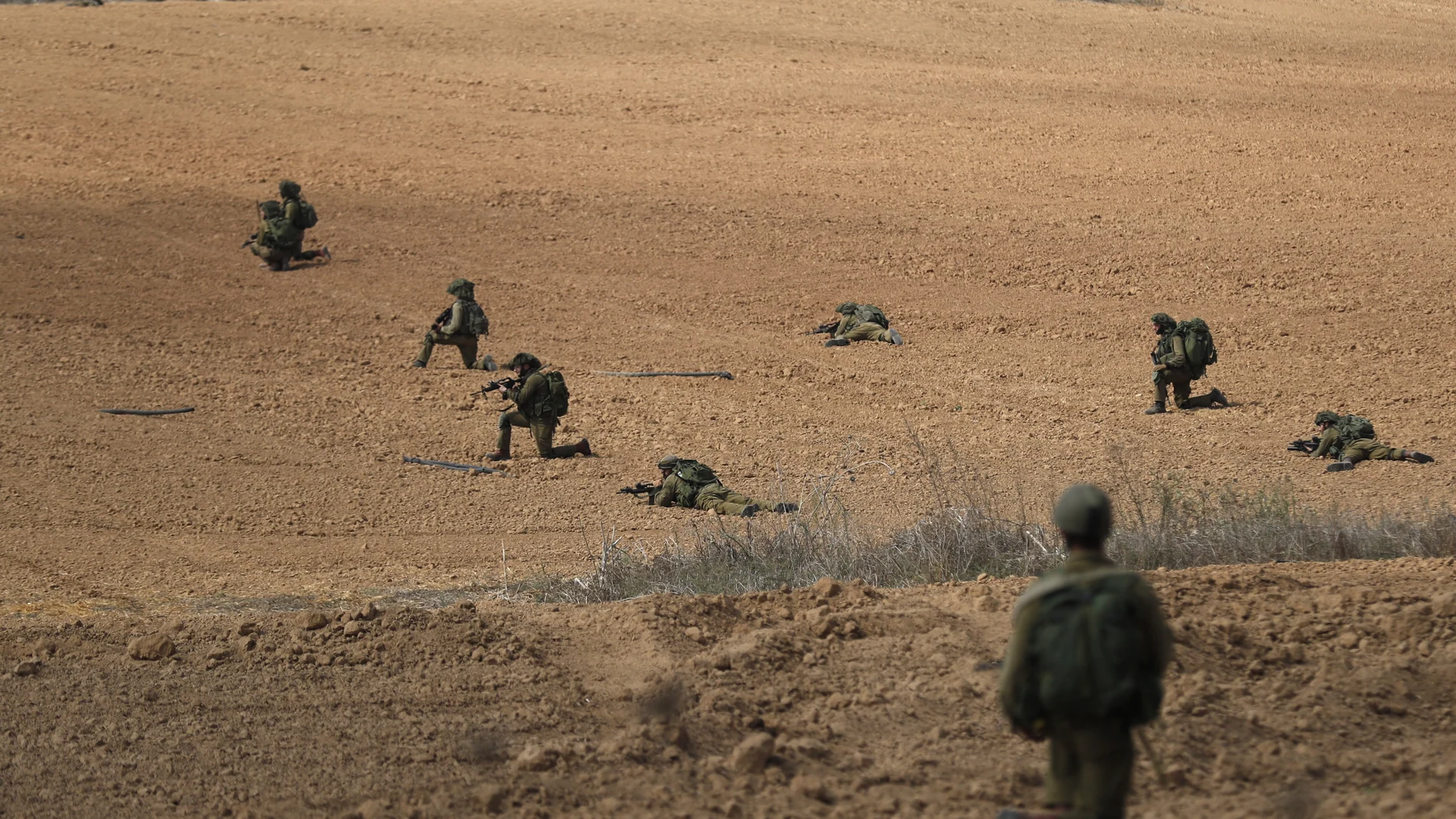 Israeli soldiers take position next to Kfar Aza kibbutz near the border with Gaza, 10 October 2023.
