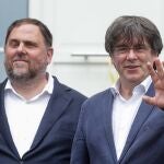 Free Catalan separatist leaders Oriol Junqueras (L) is welcomed by Former Catalan leader Carles Puigdemont ahead of a meeting at Casa de la Republica Catalana in Waterloo.