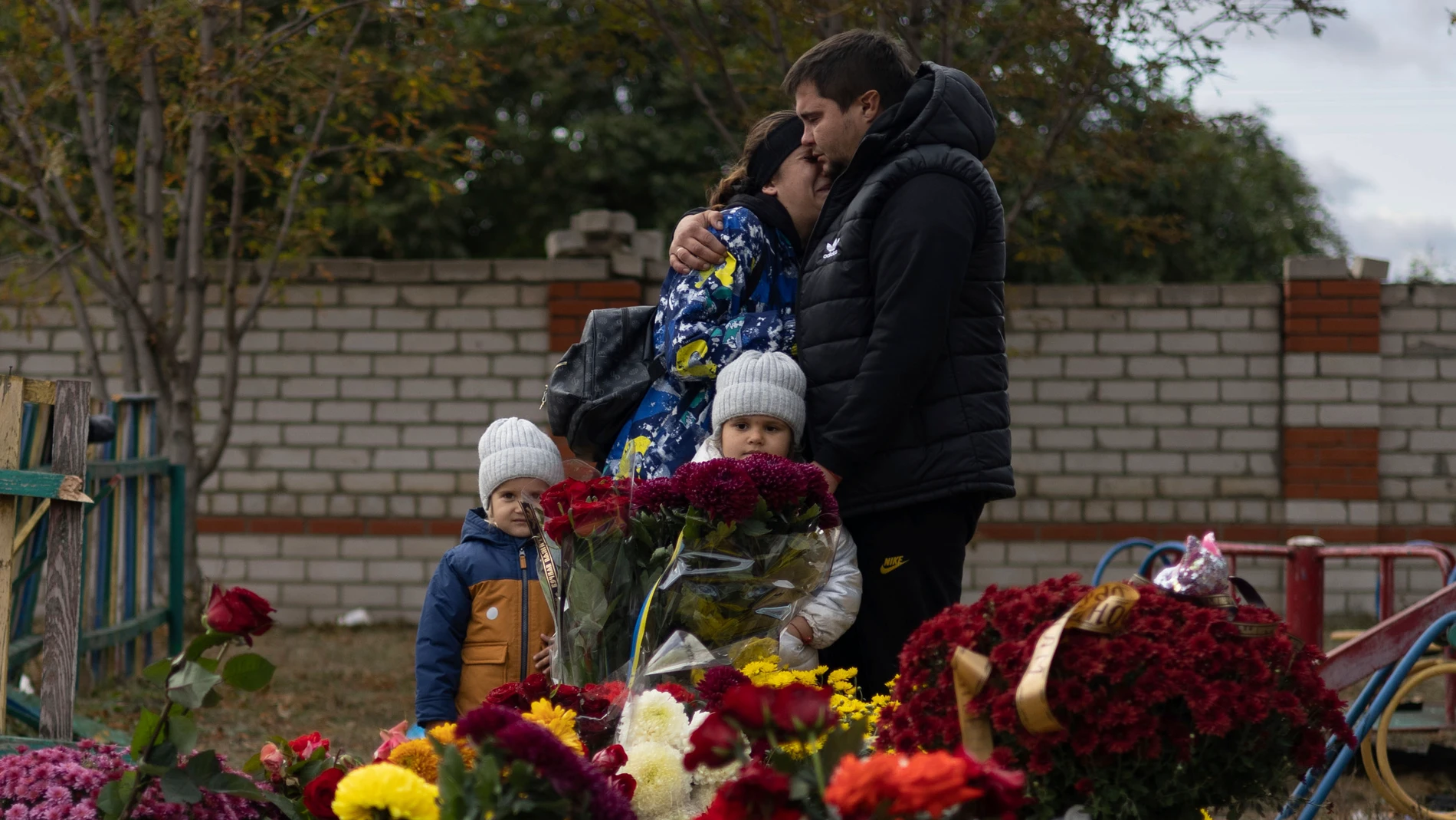 FILE - People react near the memorial for the victims of a Russian rocket attack in the village of Hroza near Kharkiv, Ukraine, Sunday, Oct. 8, 2023. A report by U.N investigators has pointed a finger at Russia as likely being responsible for the deaths of 59 civilians at a village café hit by a missile in eastern Ukraine in early October, in what was one of the deadliest strikes since the Kremlin’s forces launched a full-scale invasion 20 months ago. (AP Photo/Alex Babenko, File)