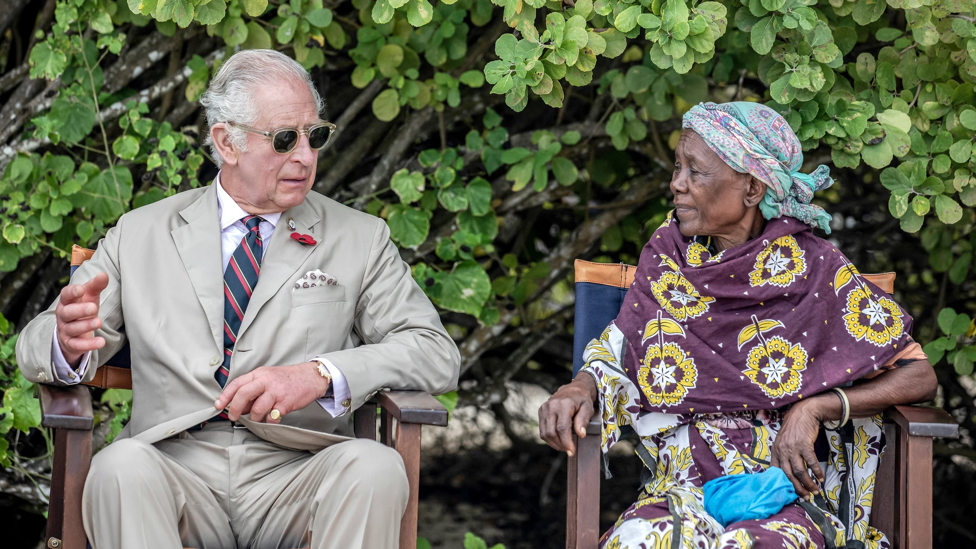 Britain's King Charles III, left, gestures as he meets with community elders during a visit to Kuruwitu Conservation Area in Kilifi, Kenya, Thursday, Nov. 2, 2023. (Luis Tato/Pool Photo via AP)