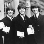 FILE - In this Oct. 26, 1965 file photo The Beatles, from left: Ringo Starr, John Lennon, Paul McCartney and George Harrison smile as they display the Member of The Order of The British Empire medals presented to them by Queen Elizabeth II in a ceremony in Buckingham Palace in London, England. The Beatles' psychedelic masterwork "Sgt. Pepper's Lonely Hearts Club Band" has been named the most popular British album in history. (AP Photo, File)