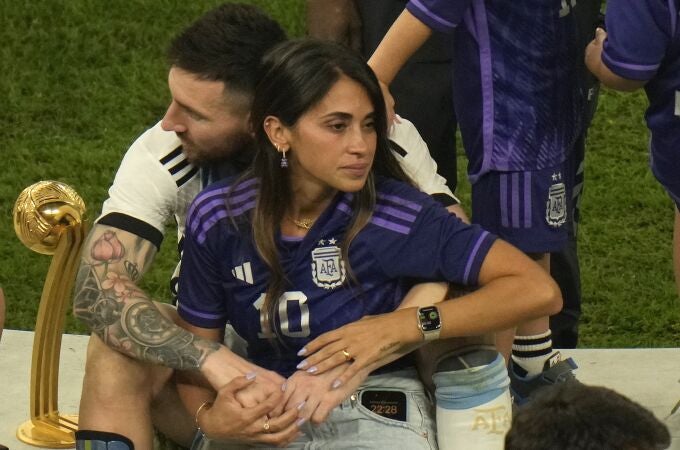 Argentina's Lionel Messi sits with his wife Antonela Roccuzzo after Argentina won the World Cup final soccer match against France at the Lusail Stadium in Lusail, Qatar