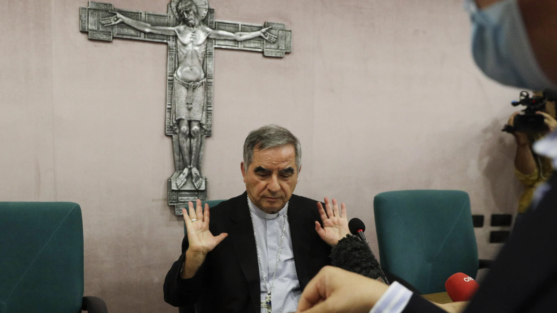 Cardinal Angelo Becciu talks to journalists during press conference in Rome.