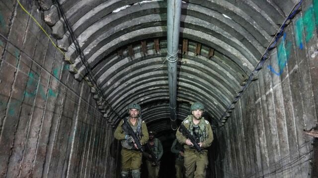 Israeli soldiers are seen in a tunnel that the military says Hamas militants used to attack the Erez crossing in the northern Gaza Strip, Friday, Dec. 15, 2023.