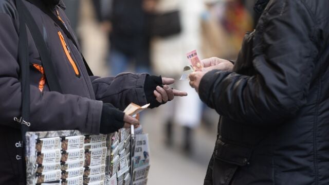 Una persona compra un décimo de la administración de lotería Doña Manolita de cara al Sorteo Extraordinario de la Lotería de Navidad.