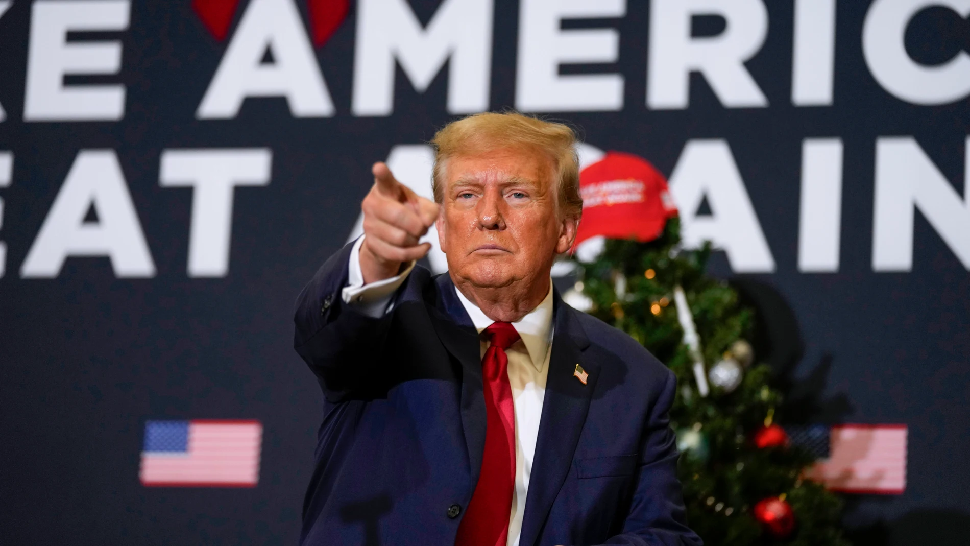 FILE - Former President Donald Trump points to supporters during rally Dec. 19, 2023, in Waterloo, Iowa. (AP Photo/Charlie Neibergall, File)