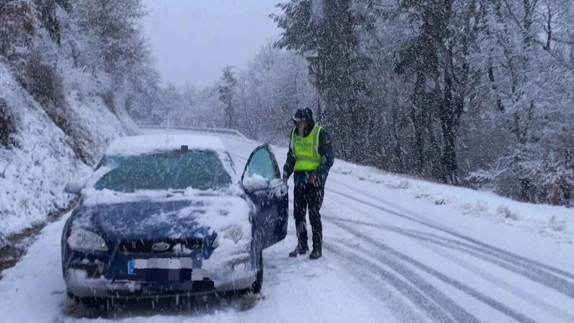 Un agente de la Guardia Civil atiende a un conductor debido a la presencia de nieve en la carretera.GUARDIA CIVIL06/01/2024