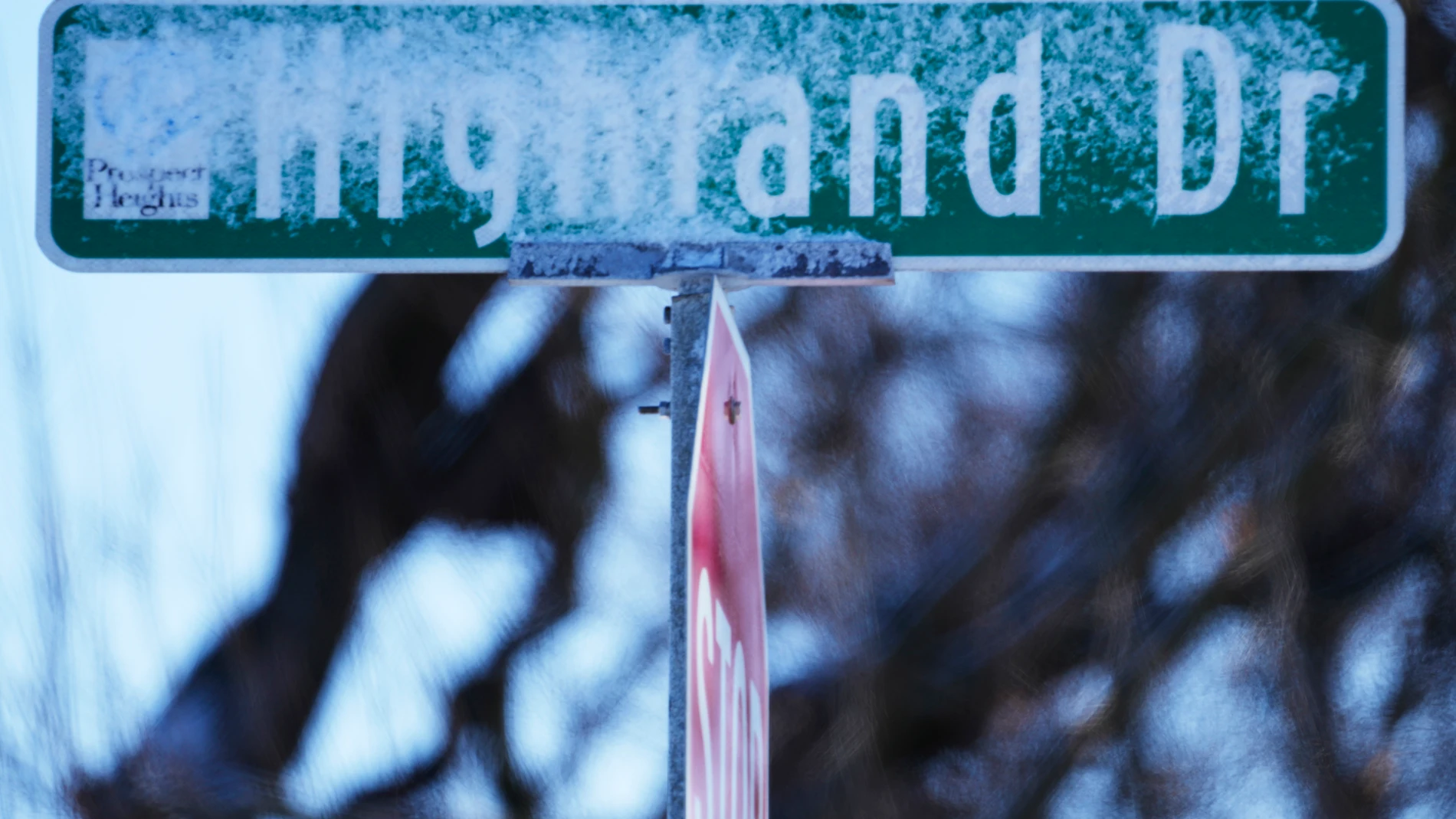 A road sign is covered by snow in Prospect Heights, Ill., Sunday, Jan. 14, 2024. Wind chill warning is in effect as dangerous cold conditions continue in the Chicago area. (AP Photo/Nam Y. Huh)