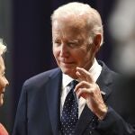 US President Joe Biden crosses his fingers while talking with President of the European Commission Ursula von der Leyen, left, at the global meeting of G20 leaders in Nusa Dua, Bali.