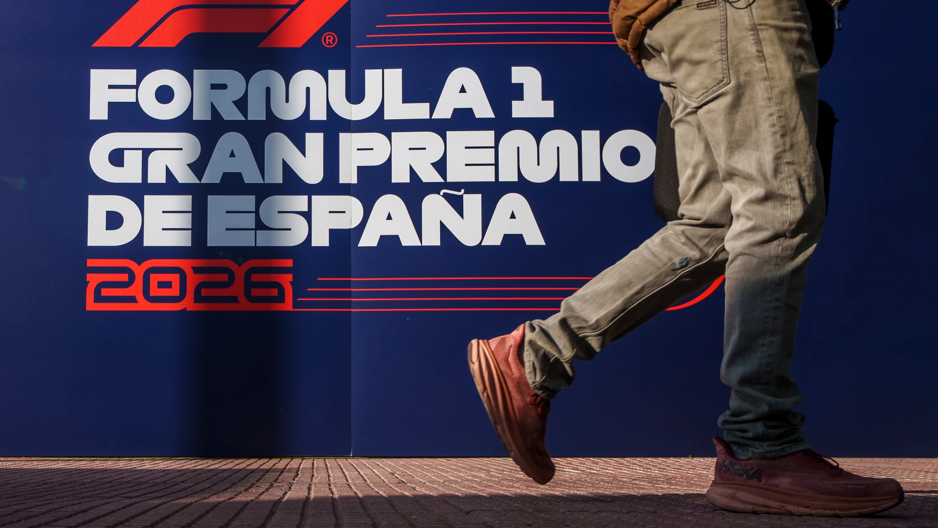 A man walks past a banner announcing the next Formula One from 2026 at the IFEMA congress centre in Madrid, Spain, Tuesday, Jan. 23, 2024. A Madrid grand prix will join the Formula One calendar from 2026 on a track that will include street and non-street sections around the city's exhibition center. (AP Photo/Manu Fernandez)