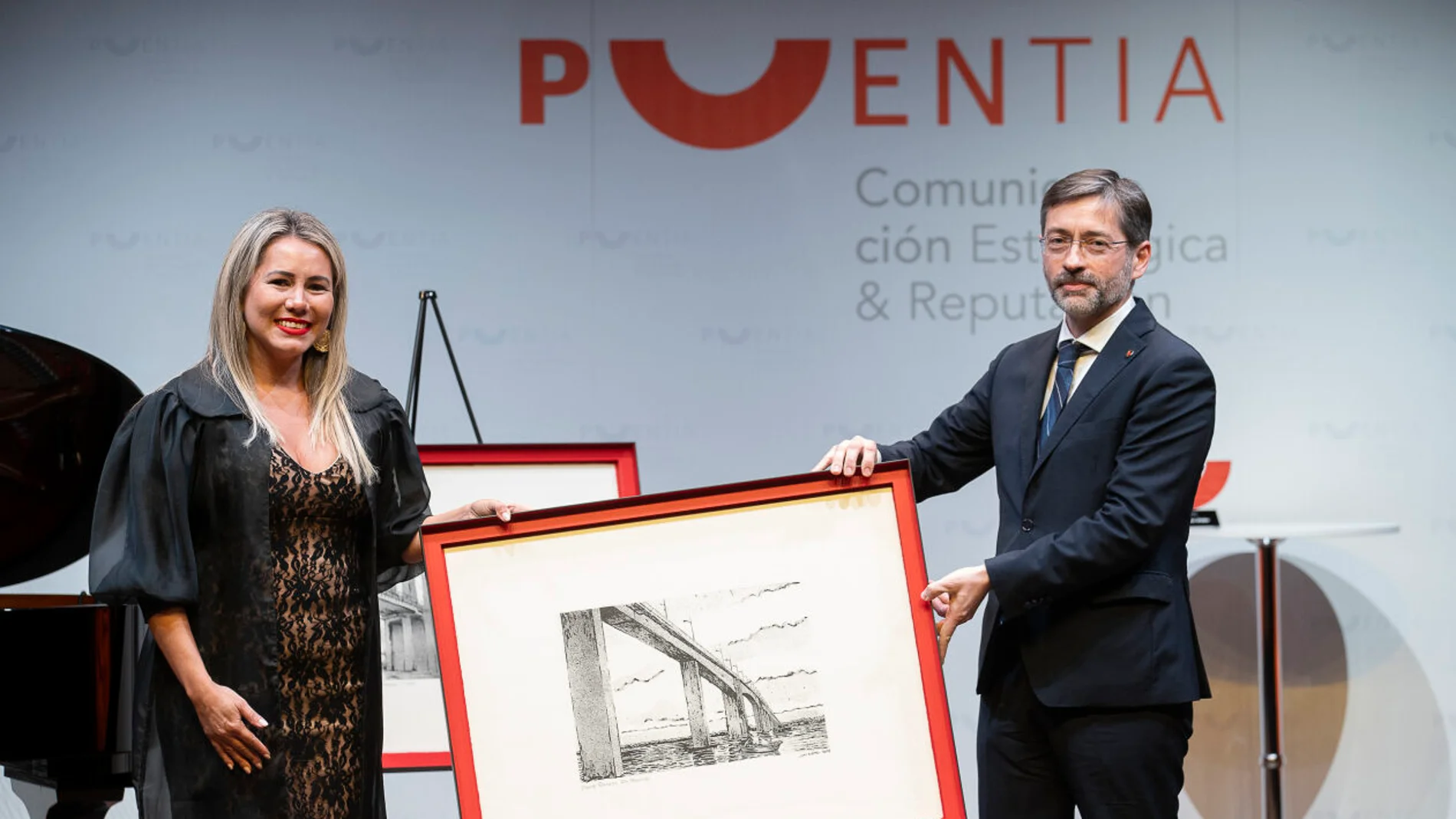 El CEO fundador de Puentia, Eduardo Álvarez, entrega un reconocimiento a la ministra de Turismo de Paraguay, Angie Duarte de Melillo