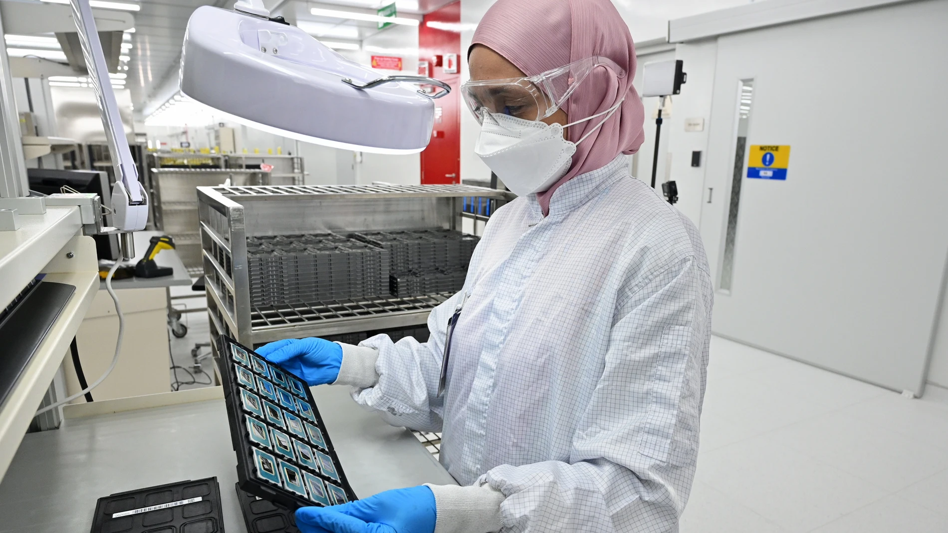 A factory technician at Intel’s Penang Assembly Test facility inspects a tray of Intel Core Ultra processors before they are shipped from the factory in Penang, Malaysia. On Dec. 14, 2023, Intel introduced the Intel Core Ultra mobile processor family. Powered by Intel’s 3D performance hybrid architecture and built on the Intel 4 process, new H- and U-Series processors deliver a balance of performance and power efficiency, immersive experiences, and AI acceleration. (Credit: Intel Corporation)
