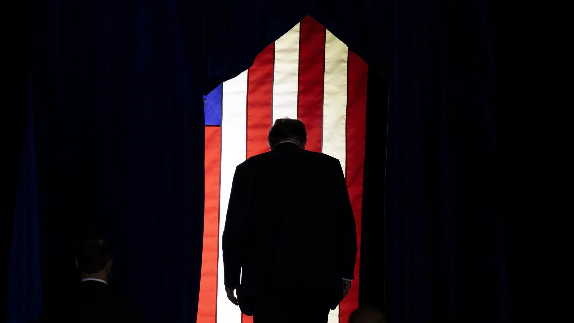 Former US President Donald J. Trump leaves at the conclusion of a campaign rally at SNHU Arena in Manchester, New Hampshire.