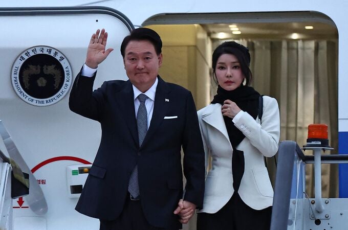 South Korea's President Yoon Suk Yeol and his wife Kim Keon Hee disembark from an aircraft after landing at London Stansted Airport, for a three-day state visit to the UK. 