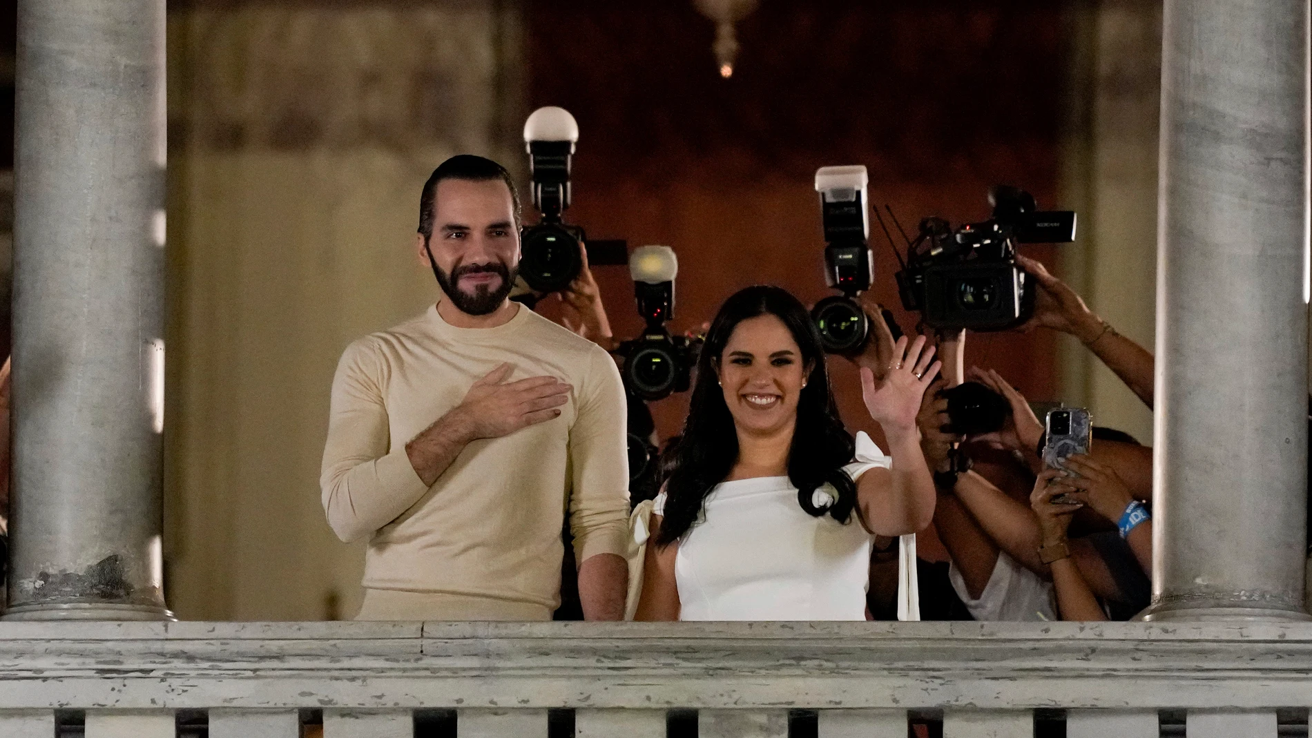 El Salvador President Nayib Bukele, left,accompanied by his wife Gabriela Rodriguez, celebrates after he was re-elected to another five-year five term, at the balcony of the presidential palace in San Salvador, El Salvador, Sunday, Feb. 4, 2024. (AP Photo/Moises Castillo) (AP Photo/Moises Castillo)