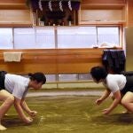 Female sumo wrestler Sayaka Matsuo (R) fights with her teammate Shiori Kanehira (L) during a training session at Nihon University's sumo club in Tokyo.