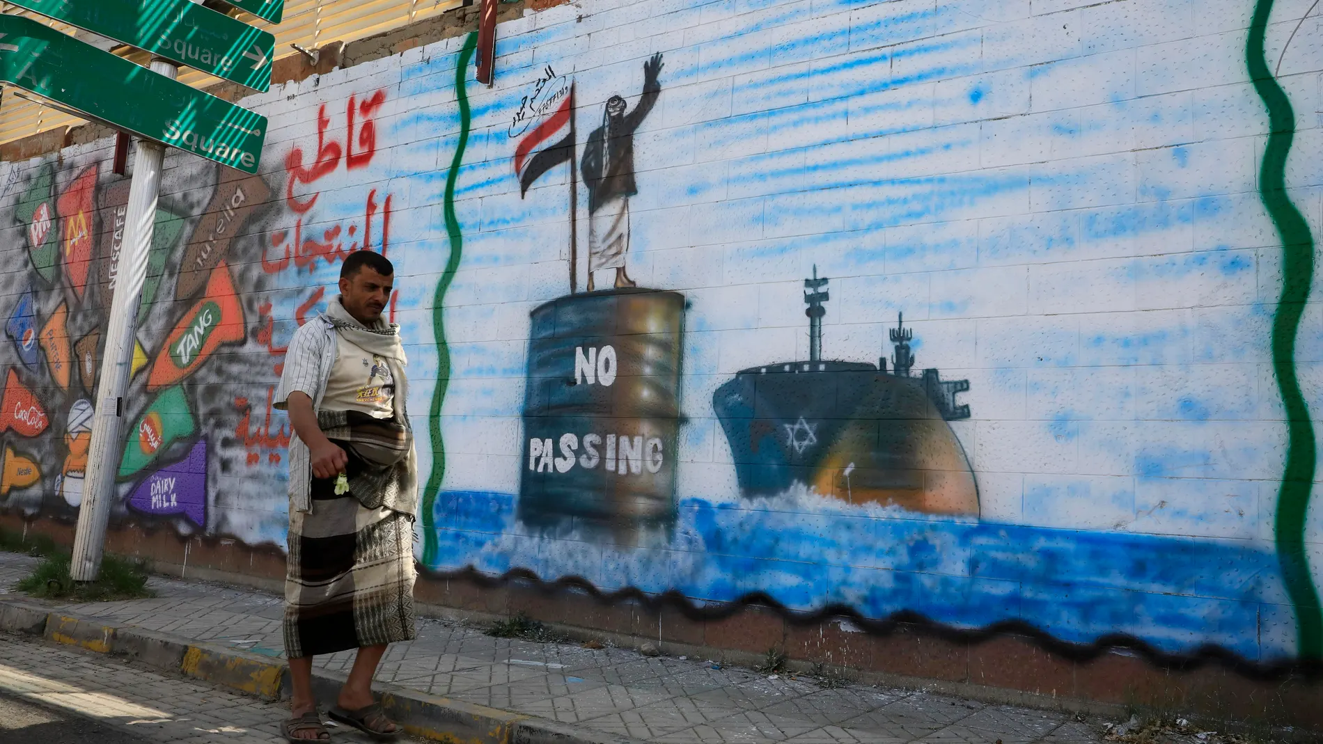 Sana'a (Yemen), 19/02/2024.- A person walks past a wall with graffiti depicting a Houthi fighter stopping an Israeli ship off the coast of Yemen, in Sana'a, Yemen, 19 February 2024. Yemen's Houthis have claimed responsibility for a new missile attack on UK-registered cargo ship in the Gulf of Aden off the coast of Yemen, according to a statement by Houthi military spokesman Yahya Sarea. The attack came just a day after the US forces launched five strikes on Houthi targets, including an unmann...
