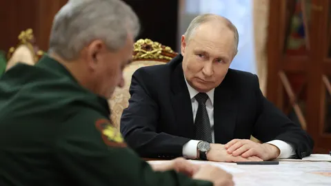 Russian President Vladimir Putin meets with Russian Defence Minister Sergei Shoigu