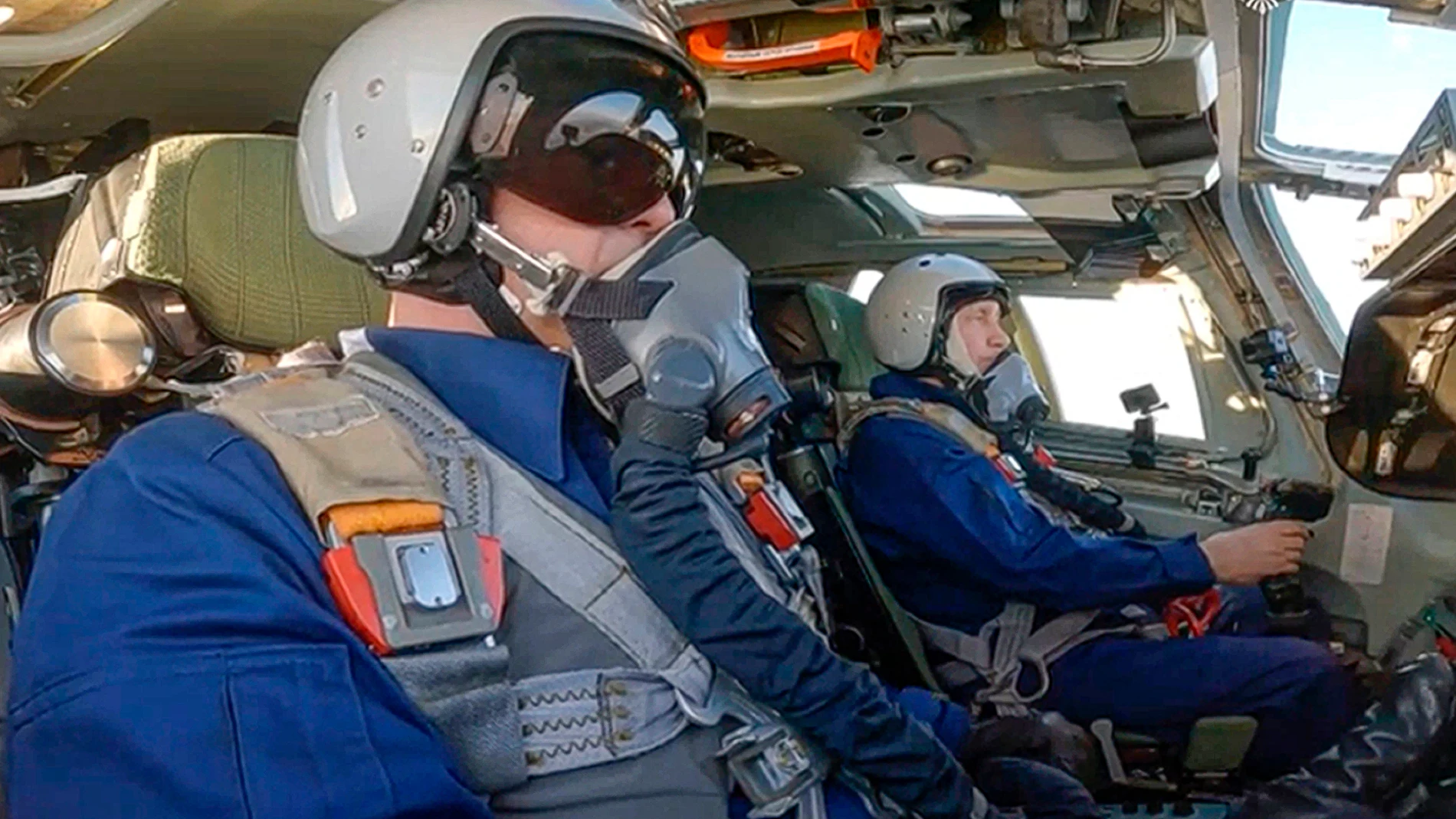In this photo taken from video released by the Kremlin Press Service, Russian President Vladimir Putin, background, is shown in a co-pilot's seat of a Tu-160M strategic bomber during a flight, Russia, Thursday, Feb. 22, 2024. (Kremlin Press Service via AP)