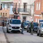 Dos agentes de la Guardia Civil y un vehículo funerario de recogida en las inmediaciones del lugar donde se ha producido el asesinato a una mujer, a 23 de febrero de 2024, en Aldea del Rey, Ciudad Real