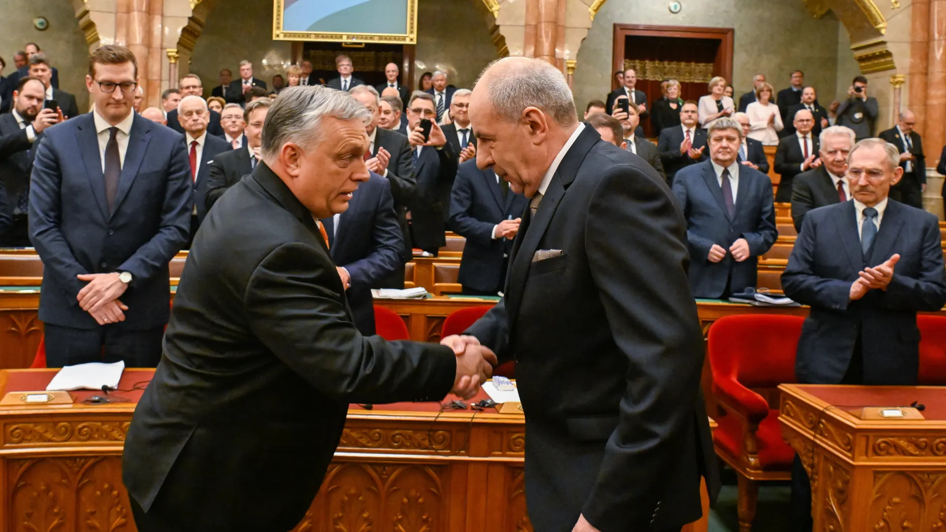Budapest (Hungary), 26/02/2024.- Tamas Sulyok, the Fidesz-KDNP candidate for head of state, (R) is congratulated by Hungarian Prime Minister Viktor Orban after Hungarian lawmakers elected him as president during the extraordinary session of the Hungarian parliament in Budapest, Hungary, 26 February 2024. Tamas Sulyok, the outgoing head of the Constitutional Court, was the sole candidate for the post, received 134 votes of 139 valid ballots, with 5 lawmakers voting against him in a secret ball...