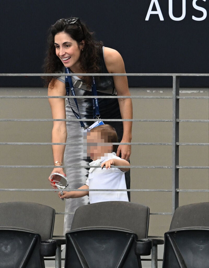 Maria Francisca Perello, wife of Rafael Nadal of Spain, watches a practice session with their son at the Queensland Tennis Centre in Brisbane, Australia