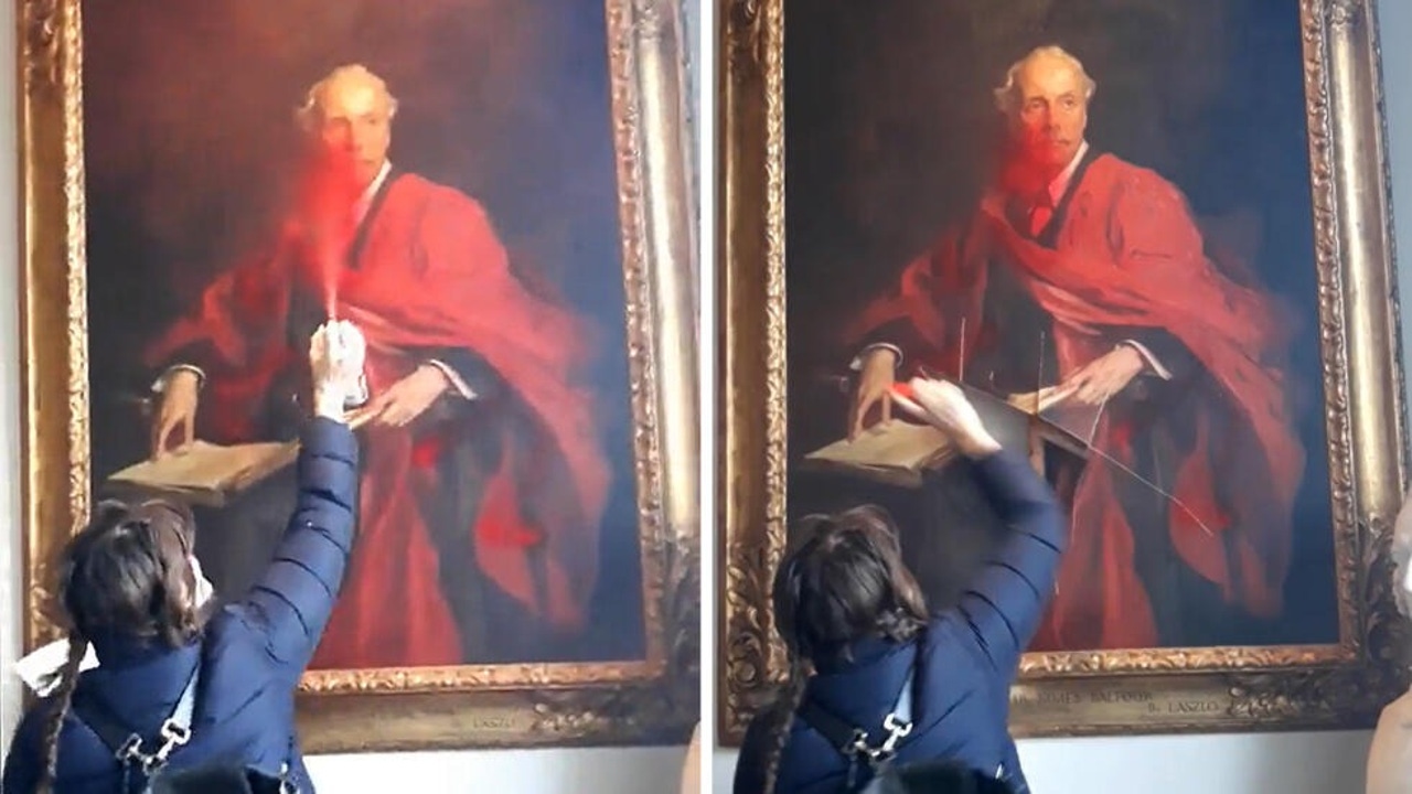 A pro-Palestinian protester paints and slashes a painting at the University of Cambridge