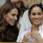Britain&#39;s Kate, Duchess of Cambridge, left, and Meghan, Duchess of Sussex speak as they sit in the Royal Box on Centre Court