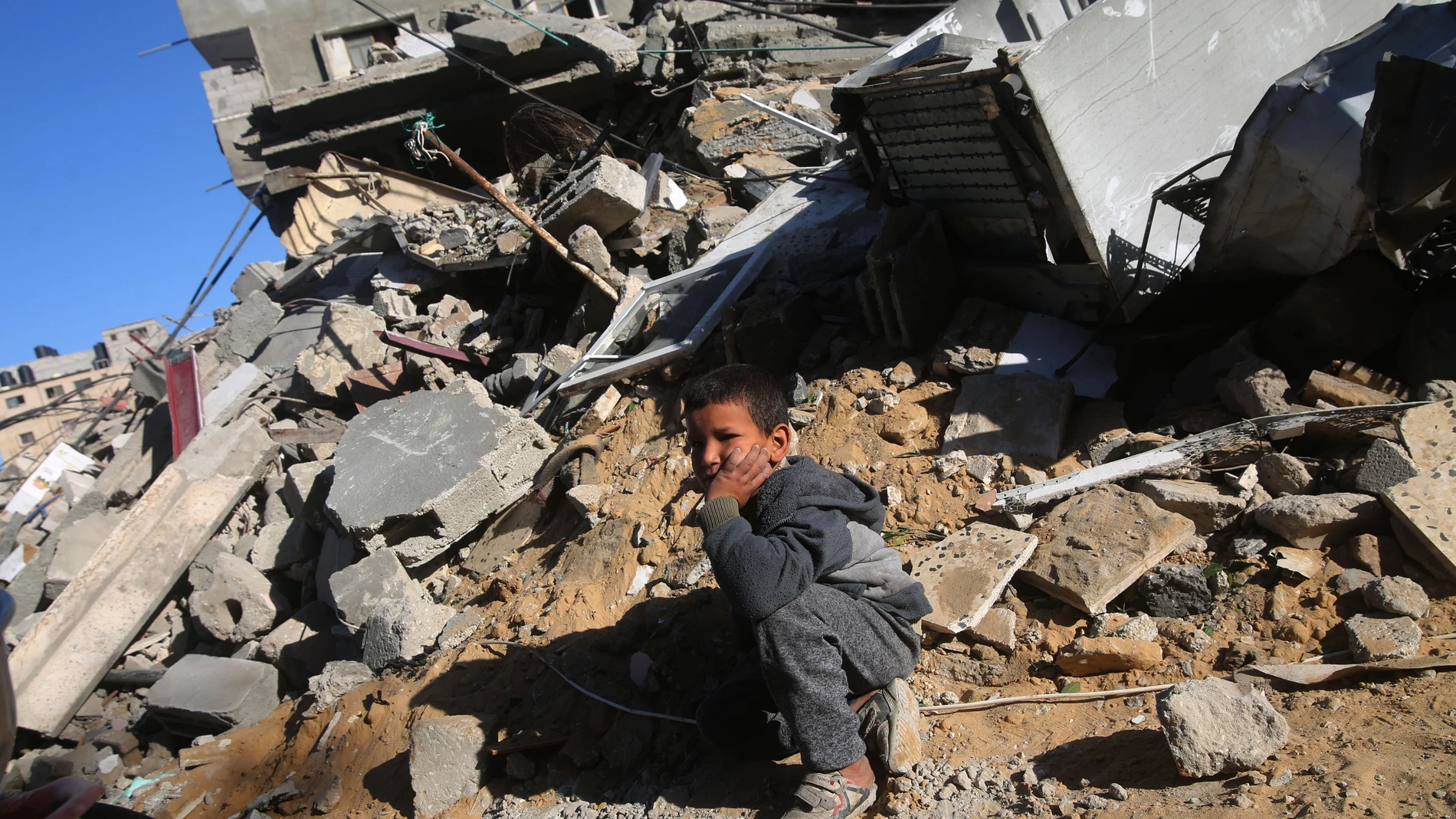 GAZA, March 12, 2024 -- A boy sits on the rubble in the southern Gaza Strip city of Rafah, on March 12, 2024. The Palestinian death toll due to the ongoing Israeli attacks on the Gaza Strip has climbed to 31,184, reported the Gaza-based Palestinian Health Ministry on Tuesday. 12/03/2024