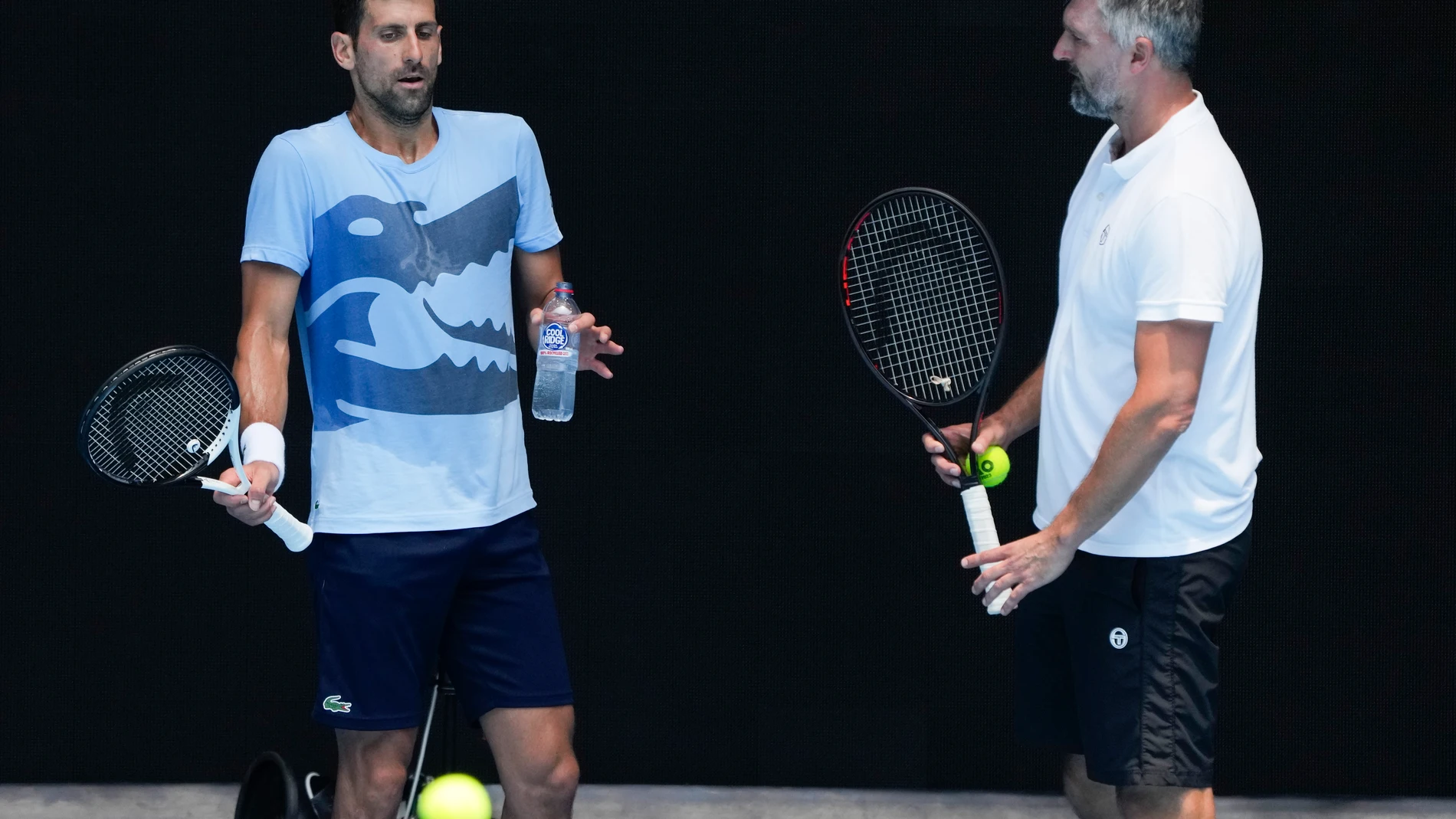 FILE - Serbia's Novak Djokovic, left, gestures as talks with coach Goran Ivanisevic during a practice session ahead of the Australian Open tennis championship in Melbourne, Australia, Friday, Jan. 13, 2023. Djokovic has split with coach Goran Ivanisevic, ending their association that began in 2018 and included 12 Grand Slam titles for the Serbian tennis player, Djokovic wrote in a post on Instagram published Wednesday, March 27, 2024. (AP Photo/Mark Baker, File)