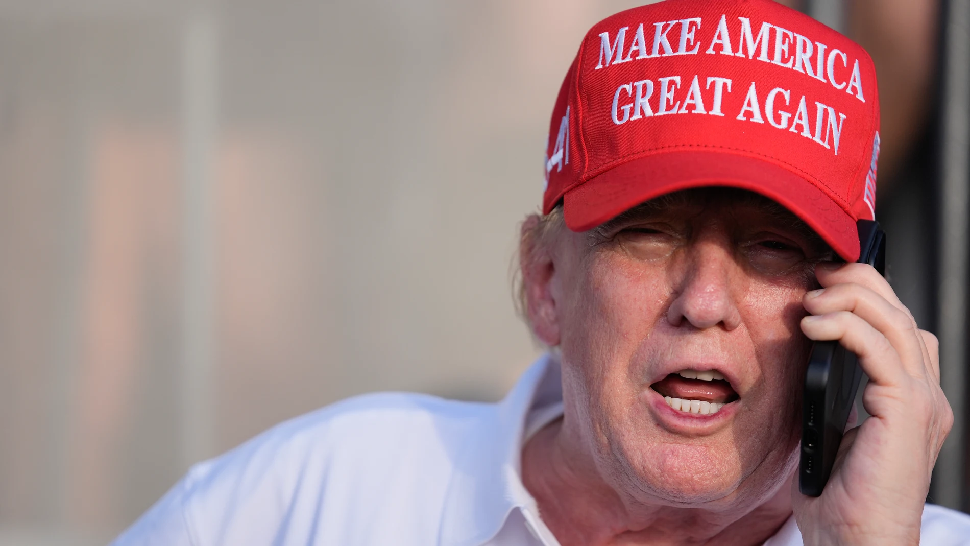 Republican presidential candidate, former President Donald Trump speaks on the phone as he watches play in the final round of LIV Golf Miami, at Trump National Doral Golf Club, Sunday, April 7, 2024, in Doral, Fla. (AP Photo/Rebecca Blackwell)
