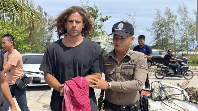 A Thai police officer escorts Spanish Daniel Sancho Bronchalo on suspicion of murdering and dismembering a Colombian surgeon from Koh Phagnan island to Koh Samui Island court, southern Thailand
