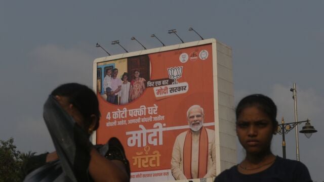Commuters are passing by Prime Minister Narendra Modi's poster ahead of the Lok Sabha election in Mumbai, India, on April 17, 2024. 