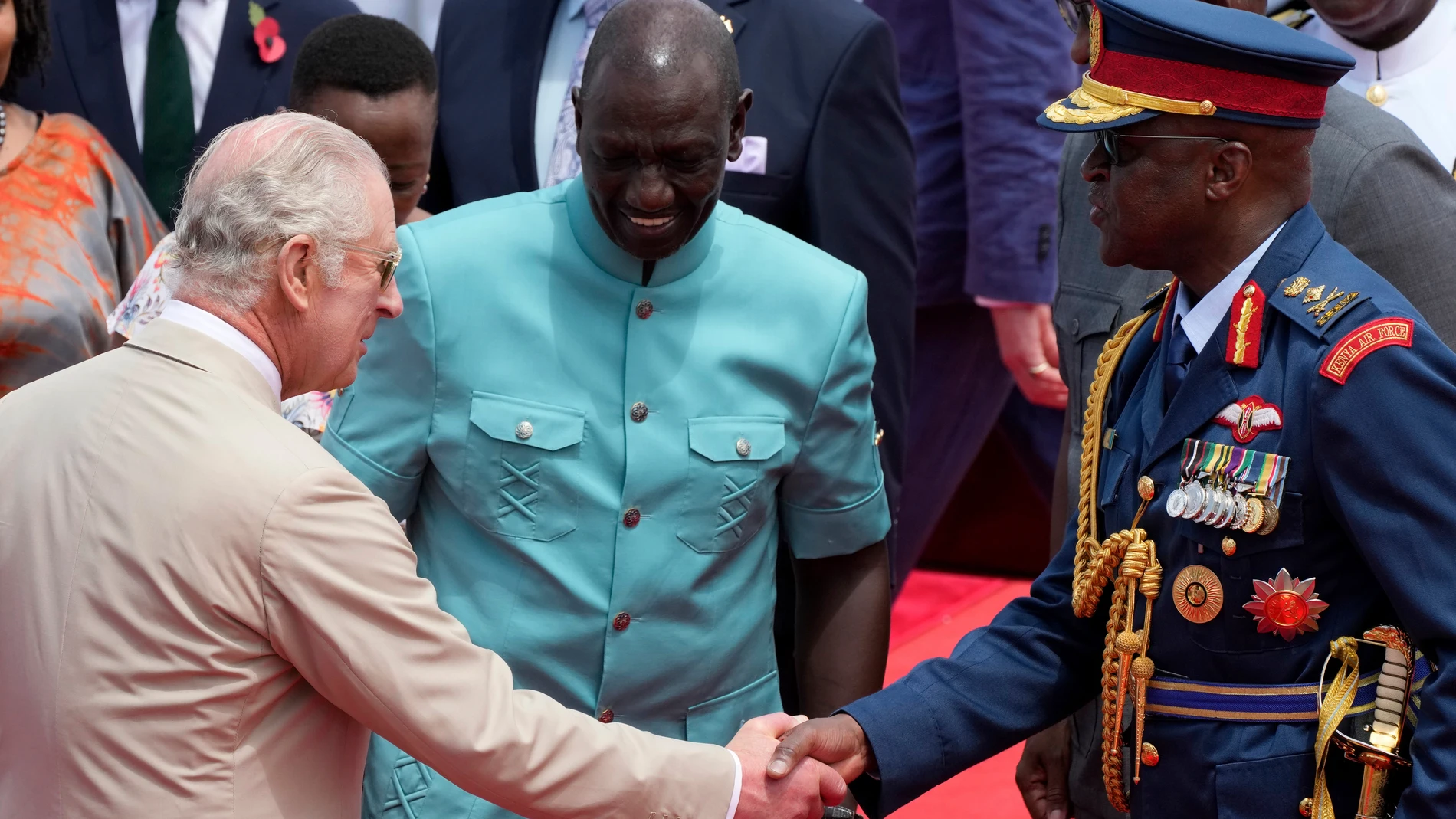FILE - Kenya's military chief General Francis Ogolla, right, shakes hand with Britain's King Charles III, left, and Kenya's President William Ruto, center, as they attend a military welcome ceremony during Charles' visit at the Mtongwe Naval Base in Mombasa, Kenya, Nov. 2, 2023. Ogolla died in a helicopter crash west of the country, President William Ruto announced Thursday, April 18, 2024, evening and declared three days of national mourning. (AP Photo/Brian Inganga, File)